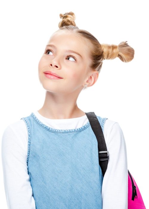 portrait of cheerful schoolchild looking up isolated on white